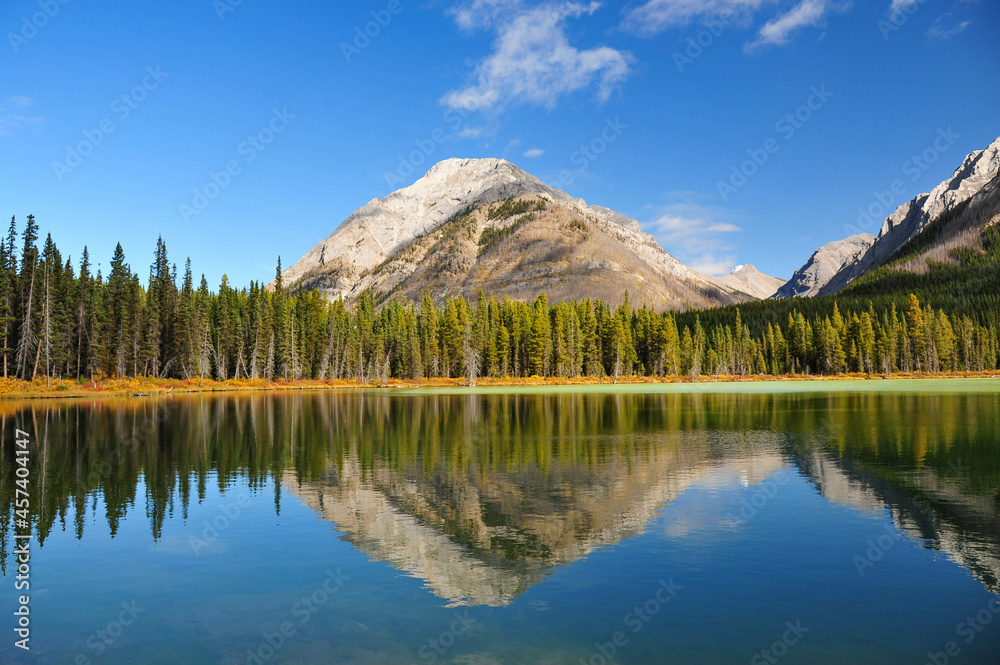 Single mountain reflected in the cold lake of the rocky mountains of Alberta