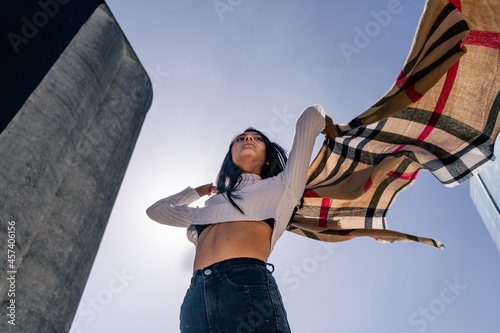 Young Latin woman moving and playing with a ruana. photo