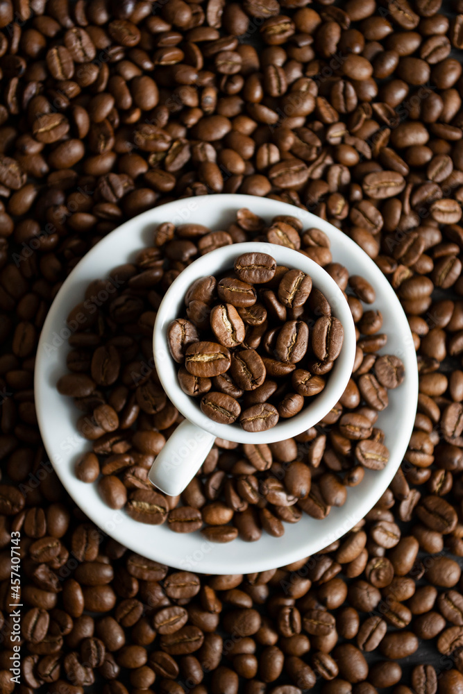 Cup with coffee beans on coffee beans background