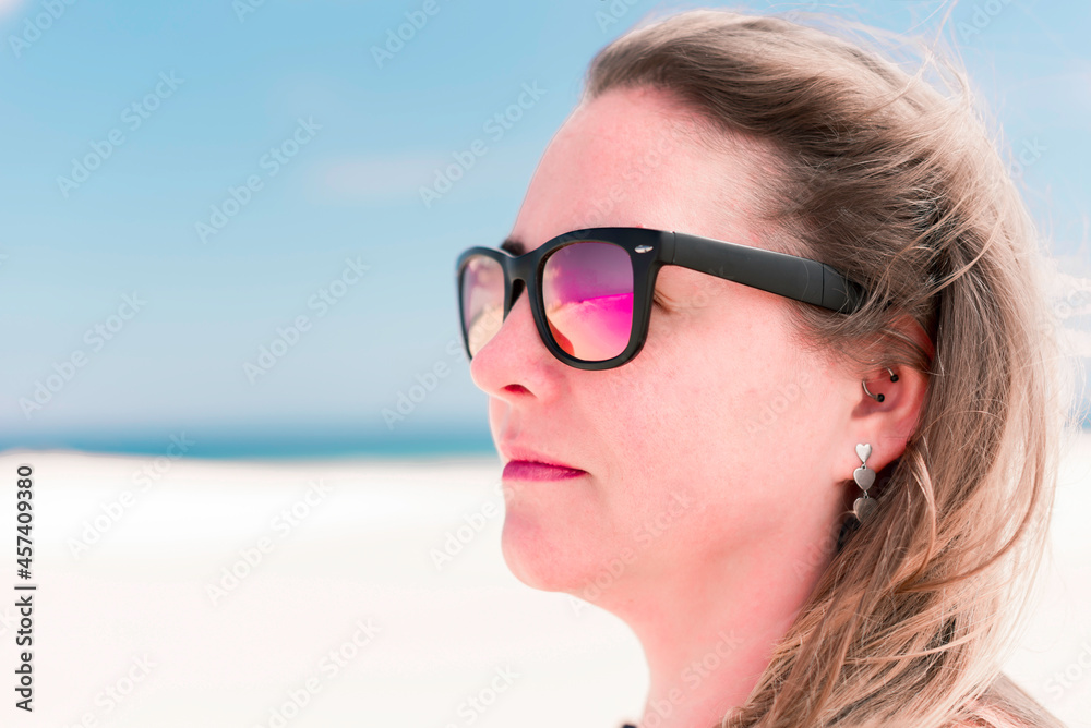 Close-up portrait of young blonde hair woman wearing sunglasses