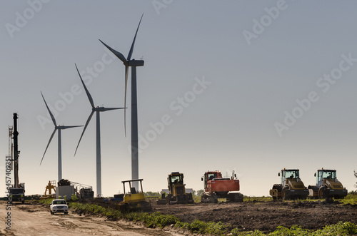 Row of three modern windmills in the countryside near Tarariras, photo
