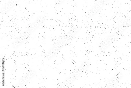 Small uneven spots and particles of debris. Abstract vector texture. Distressed uneven background. Grunge texture overlay with fine grains isolated on white background. Vector illustration. EPS10. © Nadejda