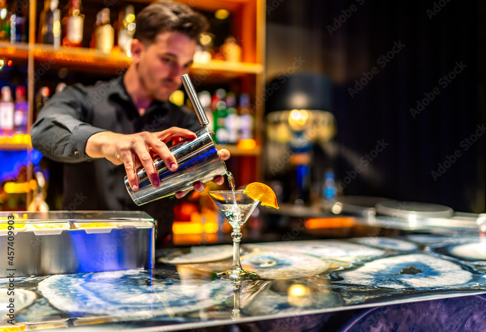 waiter serving a delicious cocktail at his place