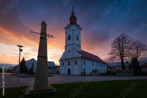 Church and whipping post in the main square of Sucany, Slovakia.