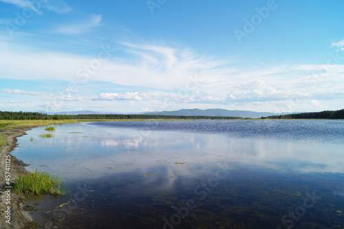 View of a mountain lake with a swampy shore