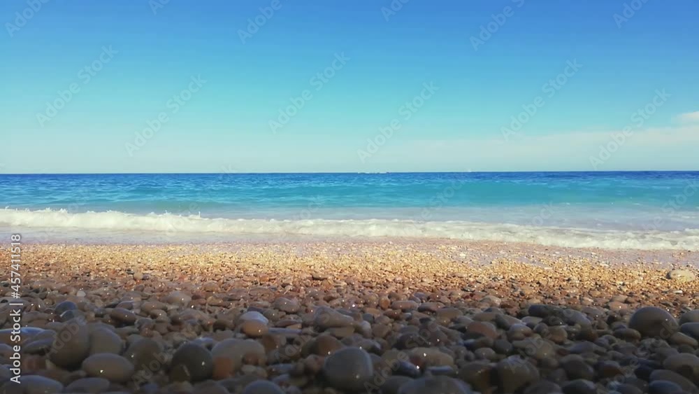 Pebble beach and blue sky on background in Alicante coast, Spain Pebble beach and blue sky on background in Alicante coast, Spain