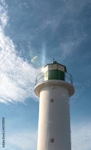The sun is reflected in a roof of Ventspils port lighthouse. View from below.