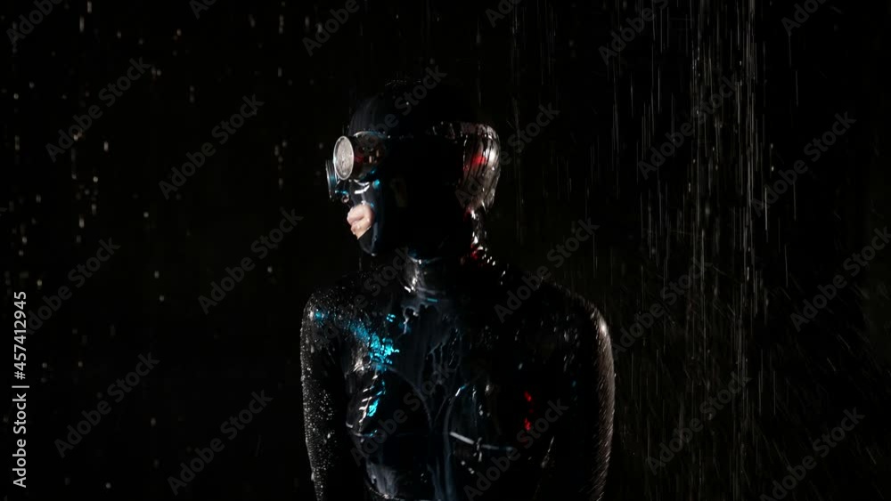 bdsm prostitute is dancing in rain, moving her body dressed in latex suit, erotic fantasy bdsm prostitute is dancing in rain, moving her body dressed in latex suit, erotic fantasy