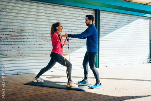 Personal trainer teaching 49 year old woman photo