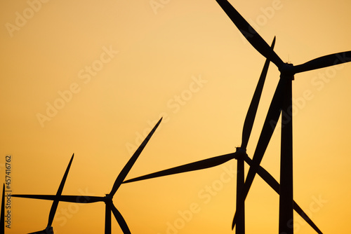 Windmills for electric power production at sunrise in Spain. photo