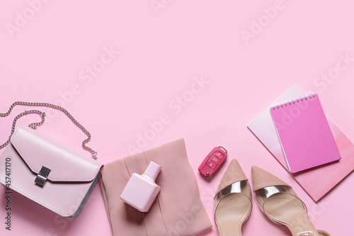 Stylish female accessories on pink background