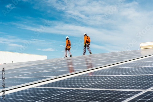 Unrecognizable solar panel technicians cheking a Spanish installation