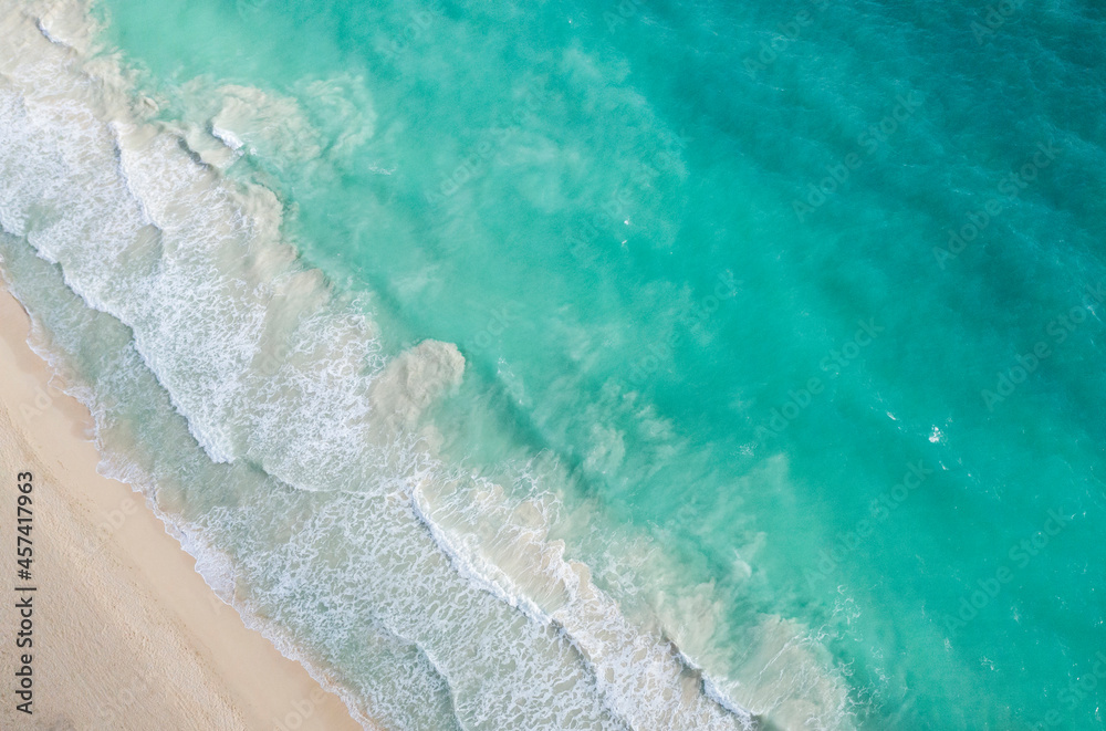 Aerial shot of the bright turquoise Hawaii ocean meeting the shore Aerial shot of the bright turquoise Hawaii ocean meeting the shore