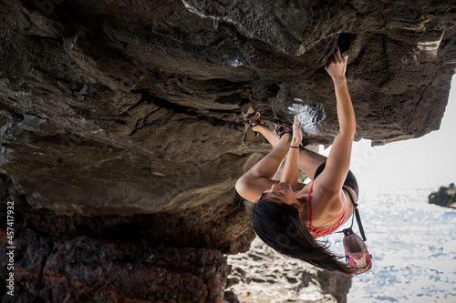 Gutsy athlete courageously hanging from an enormous rock at The Arch photo