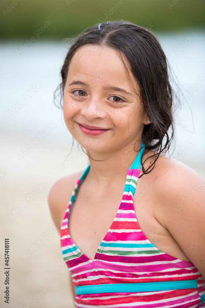 Portrait of an eleven year-old girl smiling after swimming at beach Portrait of an eleven year-old girl smiling after swimming at beach