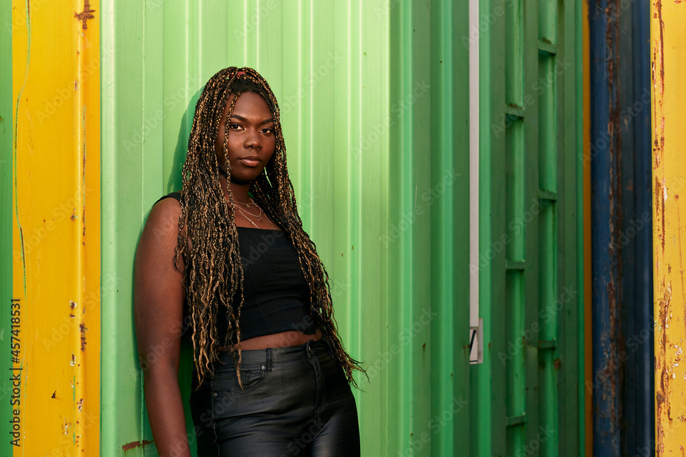 Black woman dressed in urban clothes with braids in her hair Black woman dressed in urban clothes with braids in her hair