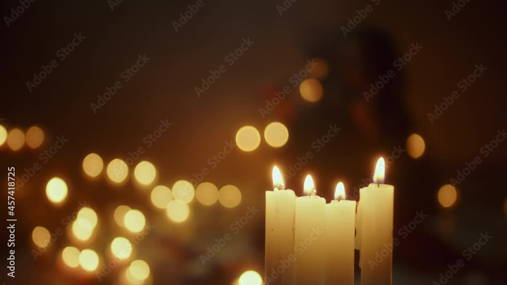 Burning candles close-up. Witch woman making rite and sacrifices at night, using black witchcraft during full moon. Halloween, traditional american holiday concept. 