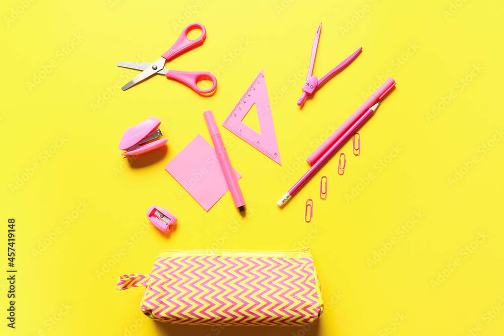 Pencil case and stationery on yellow background Pencil case and stationery on yellow background