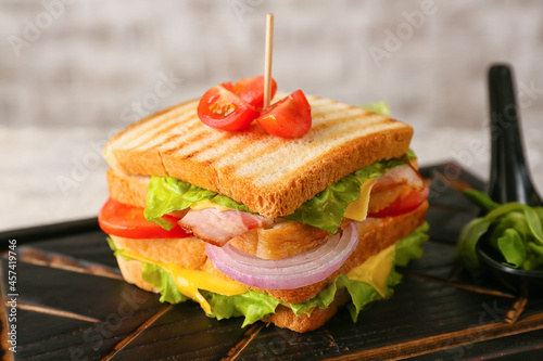 Board with tasty sandwich o...