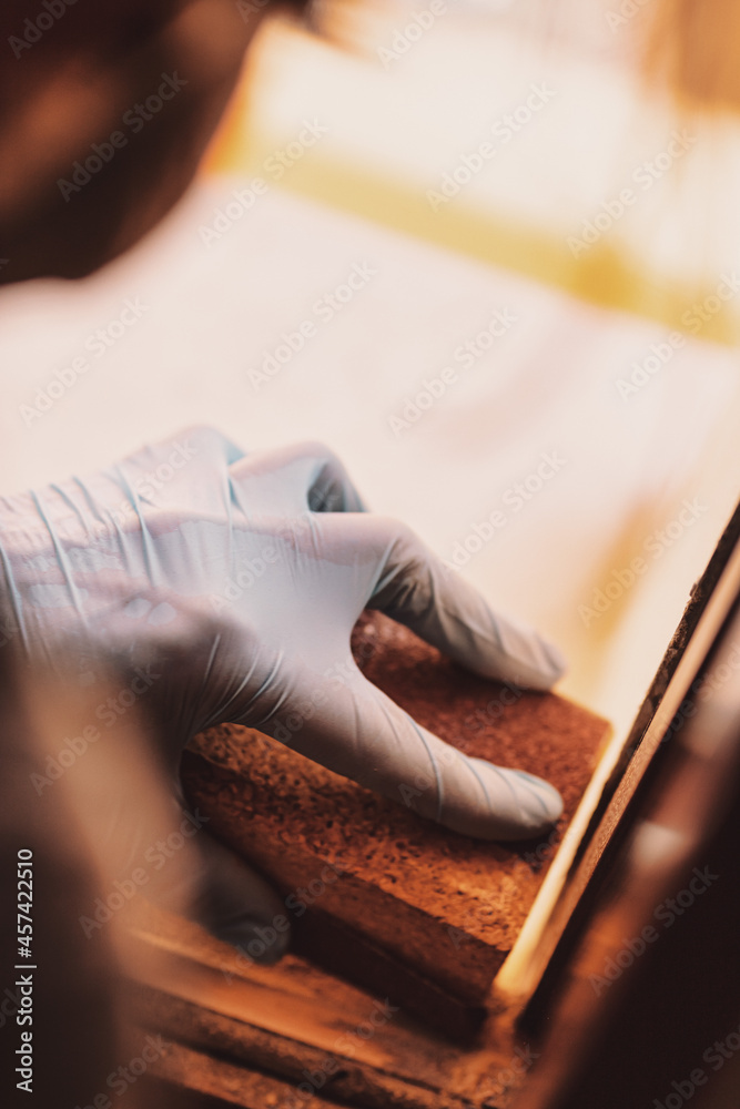 woman hands sandpaper and repair windows and wooden frames