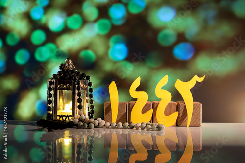 Muslim lamp with tasbih against blurred lights. Islamic New Year celebration photo