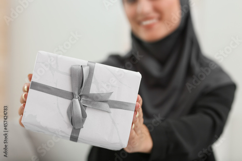 Young Muslim woman with gif...