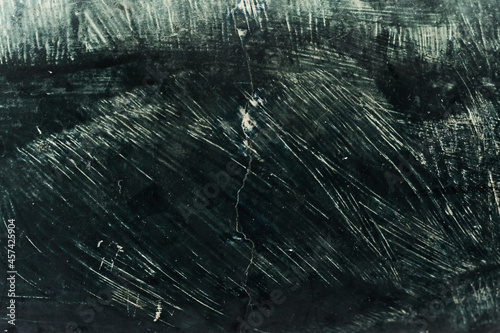 wall with broken wet, dry and destroyed advertisements in green color