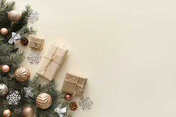 Fir branches with Christmas decor and gifts on light background