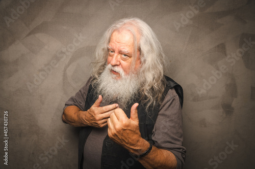 Grizzled Old Rogue with Long Gray Hair and White Beard Clowns for the Camera photo