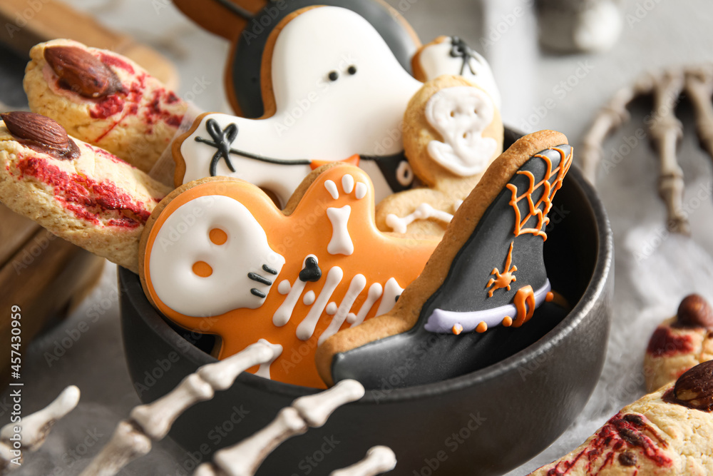 Bowl with tasty cookies for Halloween celebration on table