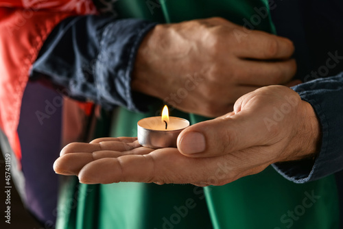 Human hands holding a lit t...