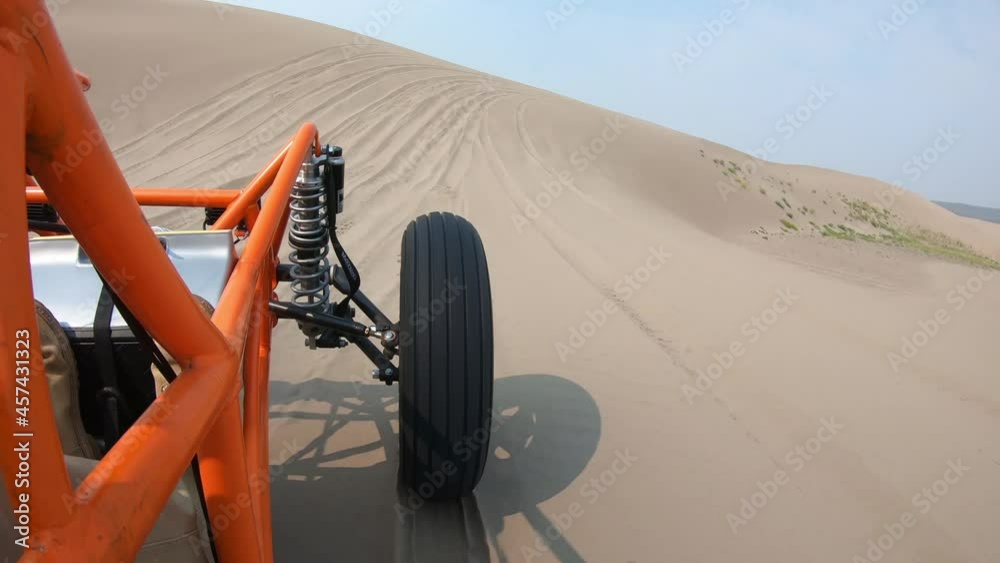 Orange Dune Buggy Driving in the Sand Dunes