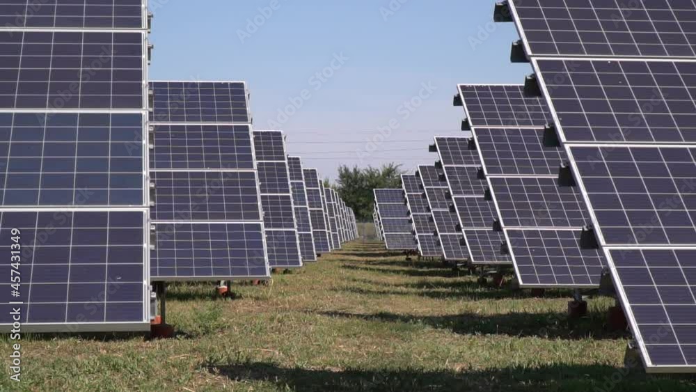 View between the rows of the solar panels at a solar power station View between the rows of the solar panels at a solar power station