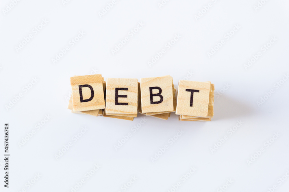 DEBT word concept. Wooden blocks with the word debt. Concept of financial crisis and problems. Risk management. DEBT word concept. Wooden blocks with the word debt. Concept of financial crisis and problems. Risk management.