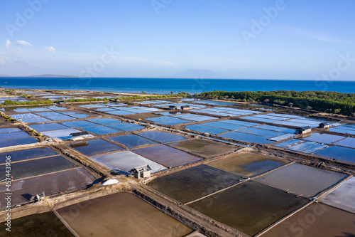 Aerial drone view of large salt fields located on the northern coast of Bali in Pemuteran coastal town to be precise and situated near the ocean to collect the water from the sea.