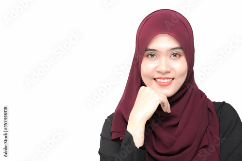 A beautiful Asian Muslim woman is smiling, on isolated white background, with copy space.