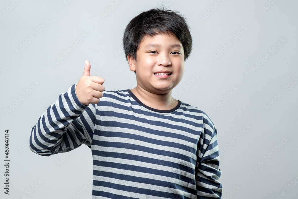 Portrait of a cute Asian boy smiling with happiness, on white background. Portrait of a cute Asian boy smiling with happiness, on white background.