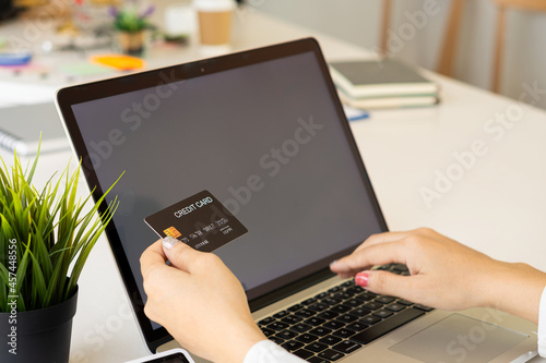 woman holding credit card and using laptop to work business people or entrepreneurs working, online shopping, ecommerce, concept internet banking, money spending, taxes