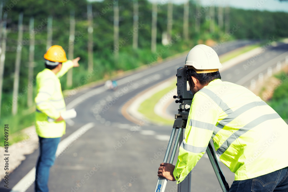 Road construction workers use orthogonal surveyors to measure angles in the horizontal and vertical planes on road construction sites. Road construction workers use orthogonal surveyors to measure angles in the horizontal and vertical planes on road construction sites.