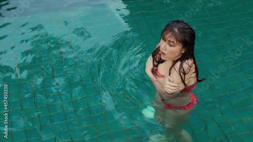 young woman is swimming in a cold plunge pool photo