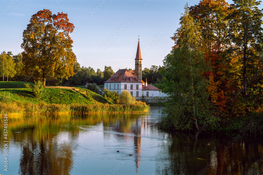 View of the Priory Palace on the shore of the Black Lake on an autumn sunny evening, Gatchina, St. Petersburg, Russia