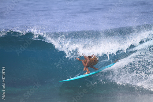 Photography surfer riding a longboard surfboard in a warm water barrel