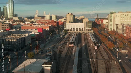 Aerial: Caltrain pulling into King St and 4th St Station in downtown San Francisco, California, USA photo