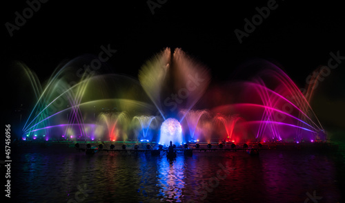 The colorful water fountain dancing in celebration festival refection color on water with dark night sky background