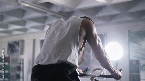 Man works out in gym on bike