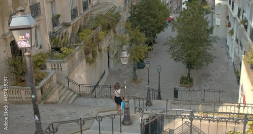 Young caucasian lady going down the stairs at Montmartre, Paris photo