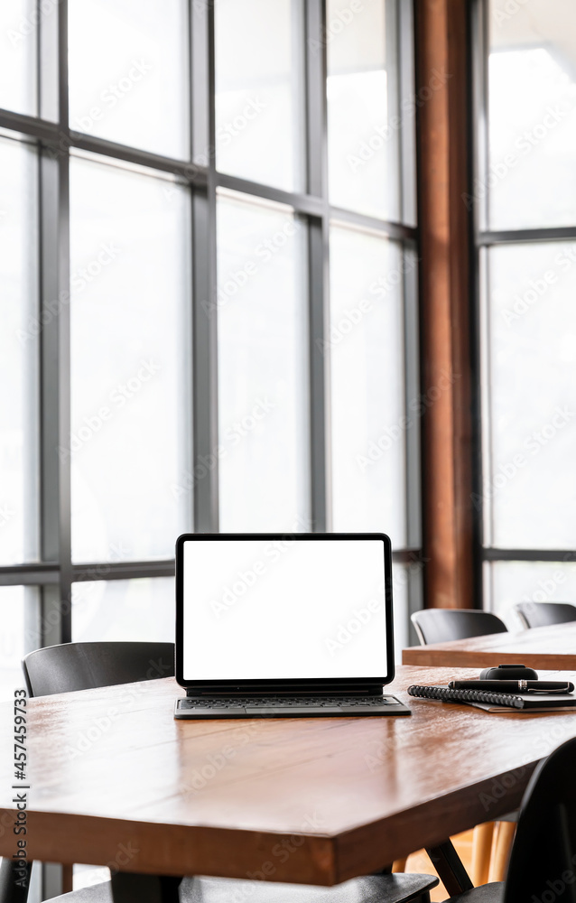 Blank screen tablet and gadget on wooden table in cafe room, vertical view. Blank screen tablet and gadget on wooden table in cafe room, vertical view.