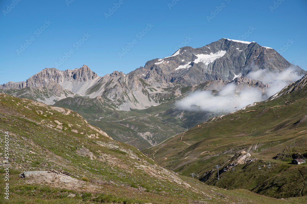 A summer mountain hiker on the summits in front of glaciers	