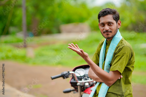 Indian farmer sitting on new motorbike.