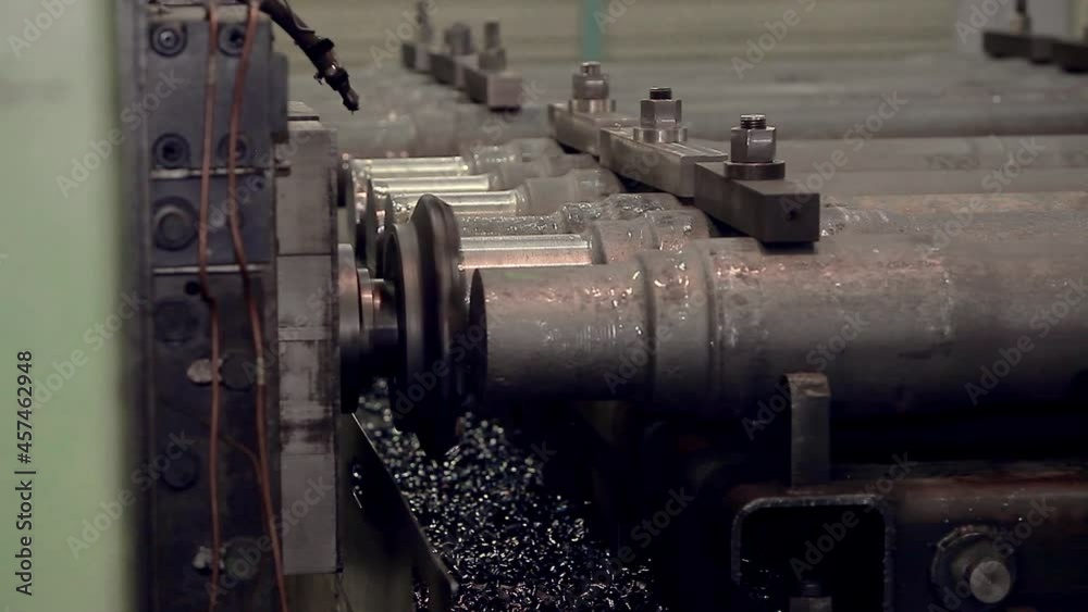 Close-up of a section of steel pipes stacked on top of each other. conveyor production of iron products Close-up of a section of steel pipes stacked on top of each other. conveyor production of iron products